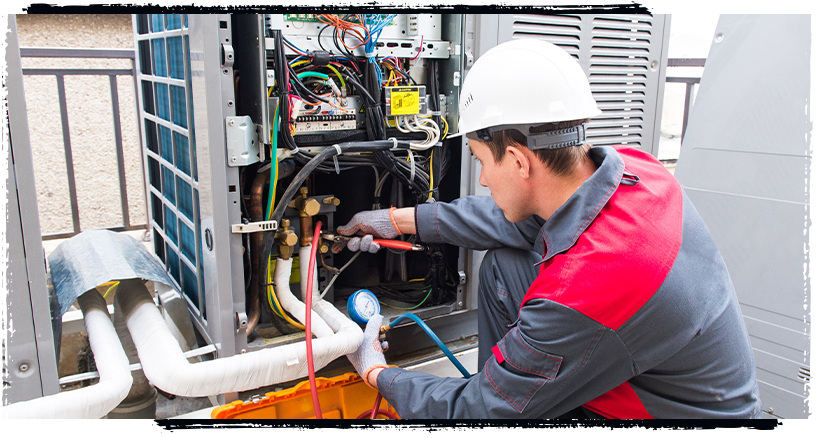 Apprentice servicing an air conditioning unit